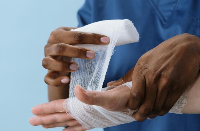 Medical professional treating an injured hand